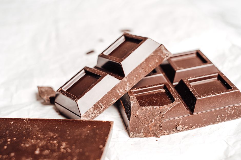 A close-up of a broken chocolate bar showing its texture